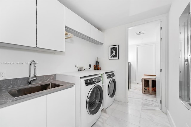 laundry room with cabinets, sink, and independent washer and dryer