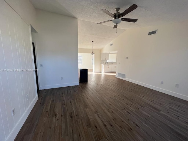 unfurnished living room with a textured ceiling, high vaulted ceiling, ceiling fan, and dark hardwood / wood-style flooring