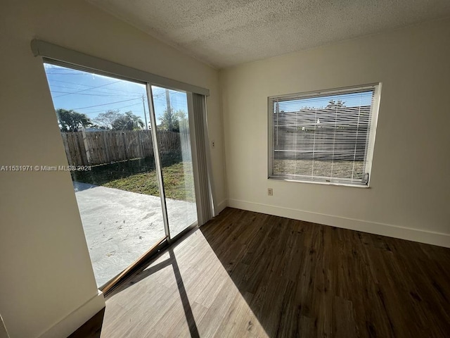 entryway with dark hardwood / wood-style floors and a textured ceiling