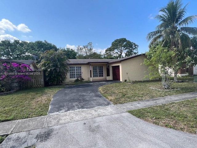 single story home featuring a front yard