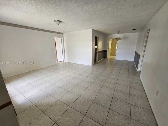 tiled spare room featuring a textured ceiling