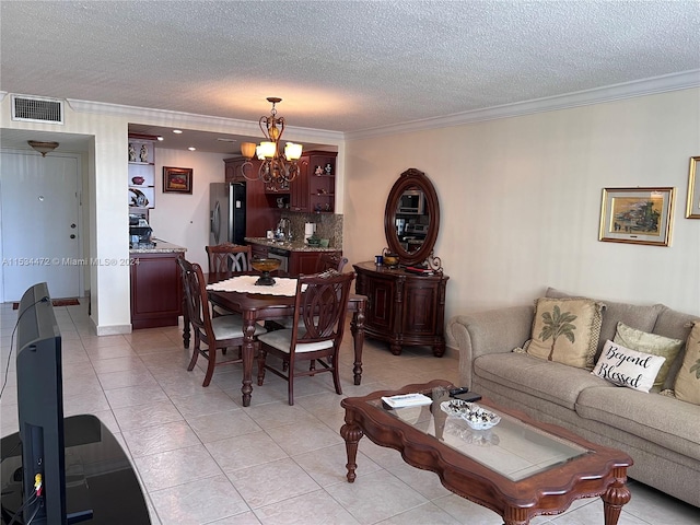 living room with a chandelier, ornamental molding, light tile floors, and a textured ceiling