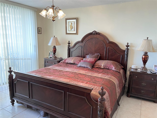 tiled bedroom with an inviting chandelier and a textured ceiling