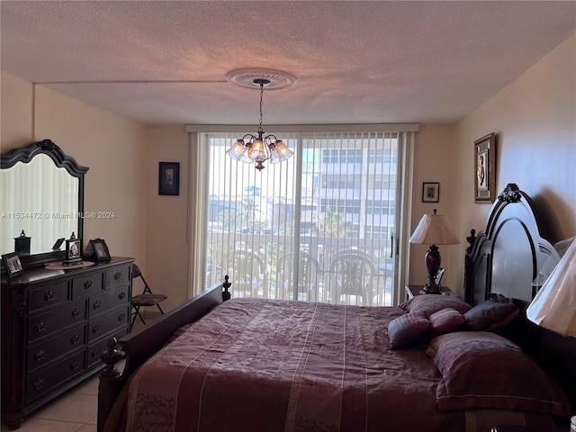 bedroom featuring light tile floors, a textured ceiling, and a chandelier