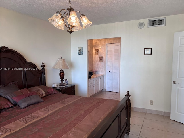 tiled bedroom with a textured ceiling and a notable chandelier