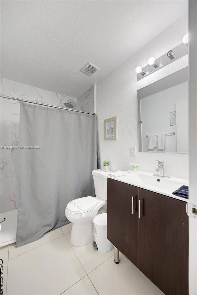 bathroom with a shower with curtain, tile patterned flooring, a textured ceiling, toilet, and vanity