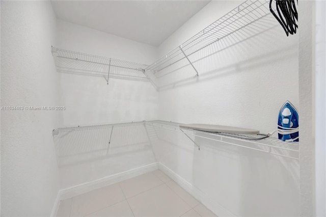 spacious closet featuring tile patterned flooring