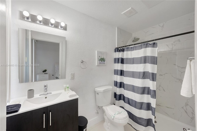 bathroom featuring toilet, vanity, a textured ceiling, and walk in shower