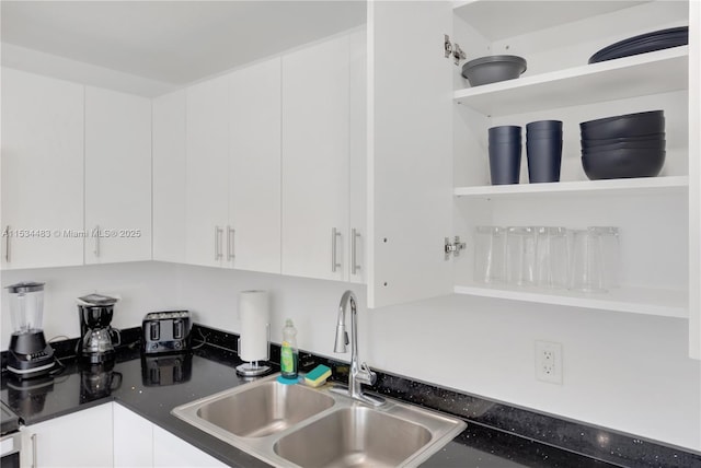 kitchen featuring white cabinetry and sink