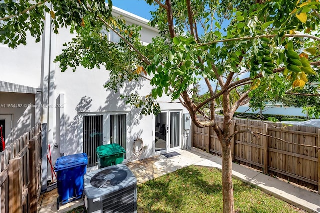 rear view of property featuring cooling unit