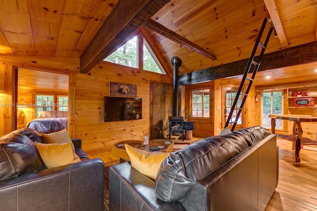 living room with wooden walls, a wood stove, wood ceiling, and light hardwood / wood-style flooring