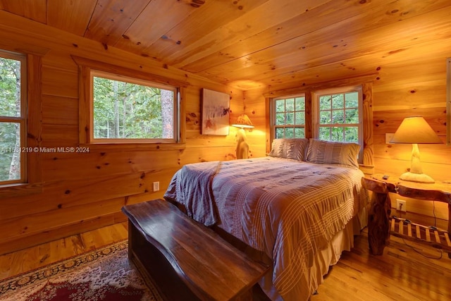 bedroom featuring wood ceiling and light hardwood / wood-style floors