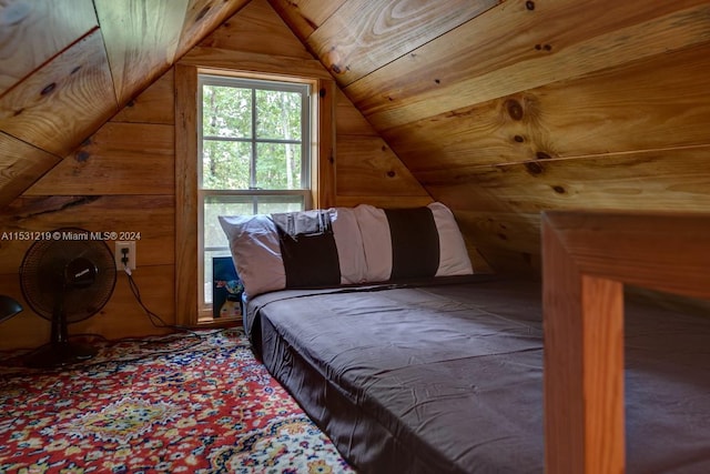 unfurnished bedroom with wooden walls and lofted ceiling