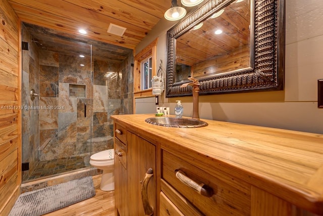 bathroom featuring vanity, wooden ceiling, hardwood / wood-style flooring, toilet, and an enclosed shower