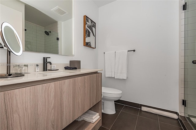 bathroom with vanity, tile floors, and toilet