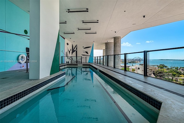 view of swimming pool with a water view