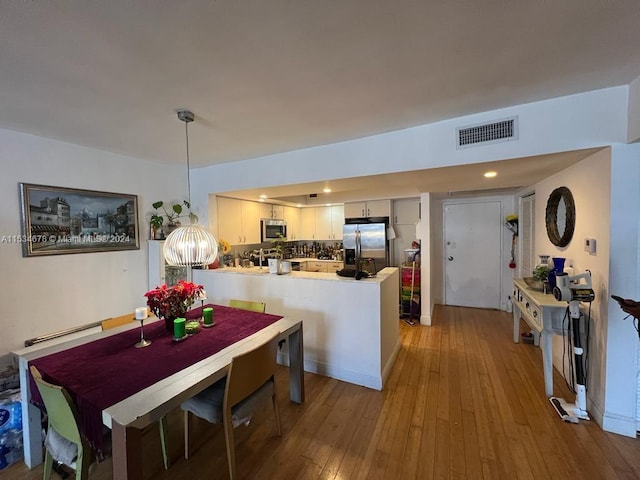 dining space with hardwood / wood-style floors