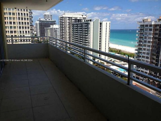 balcony with a beach view and a water view