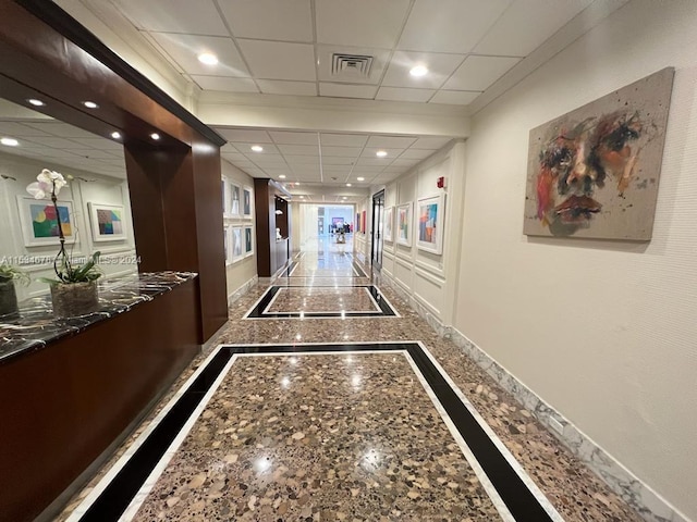 hallway with a drop ceiling