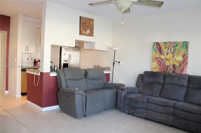 living room with light tile floors and ceiling fan