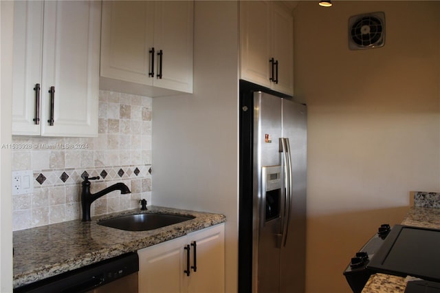 kitchen with backsplash, stainless steel appliances, white cabinets, and light stone counters