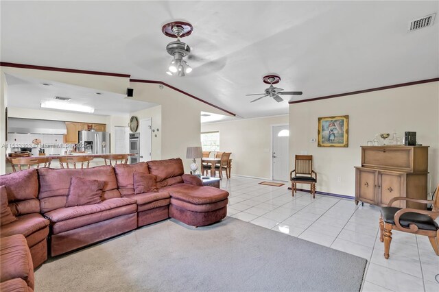 tiled living room featuring vaulted ceiling, ornamental molding, and ceiling fan