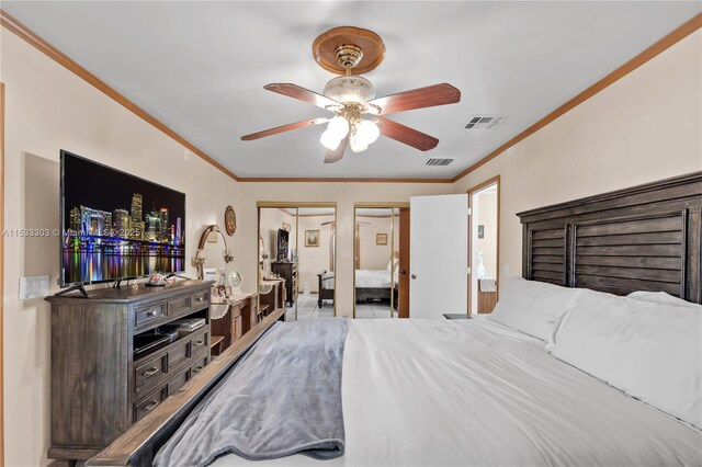 bedroom with crown molding, ceiling fan, and two closets