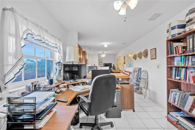 home office featuring light tile patterned floors and ceiling fan