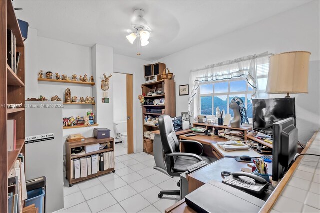 home office with light tile patterned flooring and ceiling fan