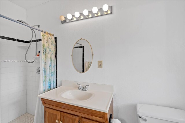 bathroom with walk in shower, vanity, and toilet