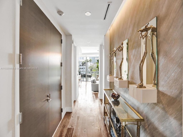 corridor with light hardwood / wood-style flooring