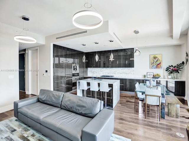 living room featuring light hardwood / wood-style flooring and sink