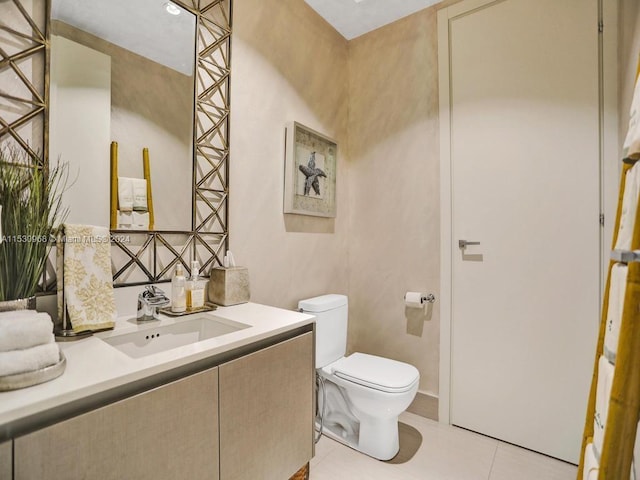 bathroom with tile patterned flooring, vanity, and toilet