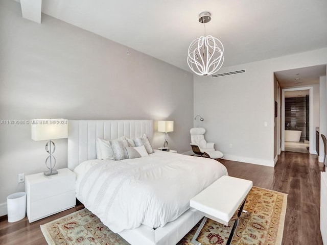 bedroom featuring dark hardwood / wood-style floors and a chandelier