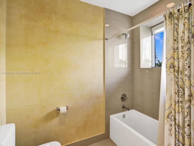 bathroom with shower / bath combination with curtain and toilet