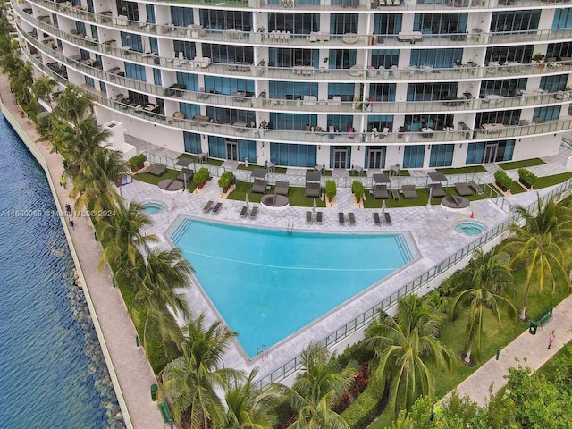 view of swimming pool with a patio and a water view