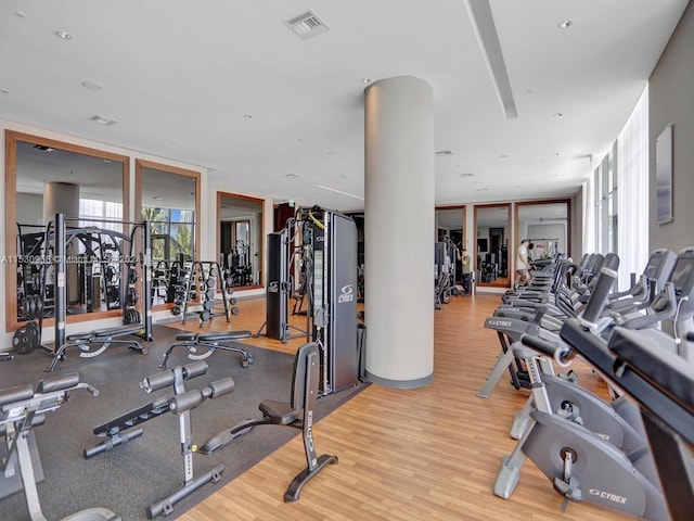 exercise room with light hardwood / wood-style floors