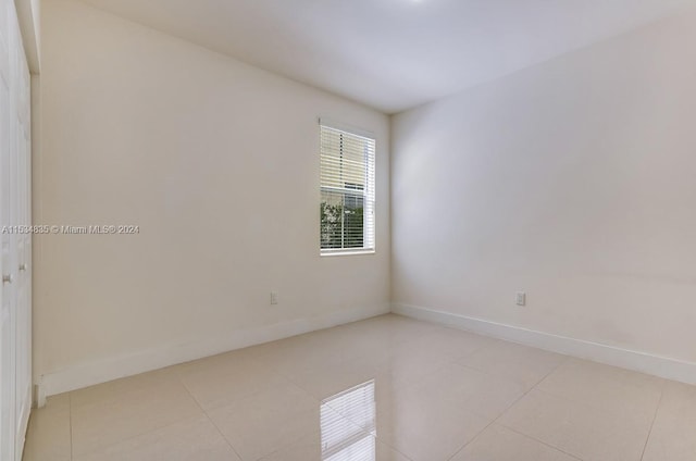 spare room with light tile floors