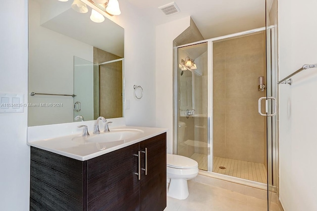 bathroom featuring an enclosed shower, toilet, vanity, and tile flooring