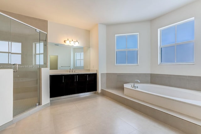 bathroom featuring plenty of natural light, separate shower and tub, tile floors, and large vanity