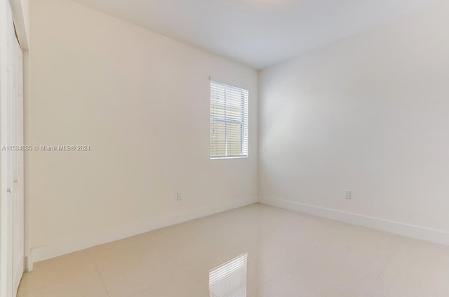 unfurnished room with light tile floors