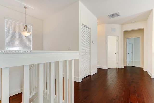 corridor featuring dark hardwood / wood-style floors