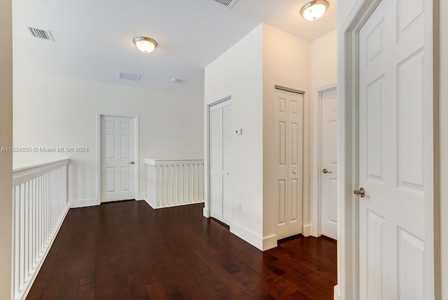 hallway with dark hardwood / wood-style flooring