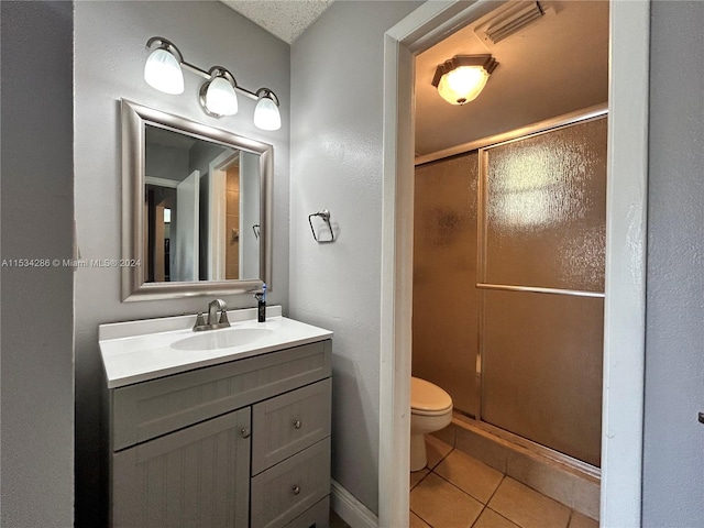 bathroom featuring an enclosed shower, toilet, large vanity, and tile flooring