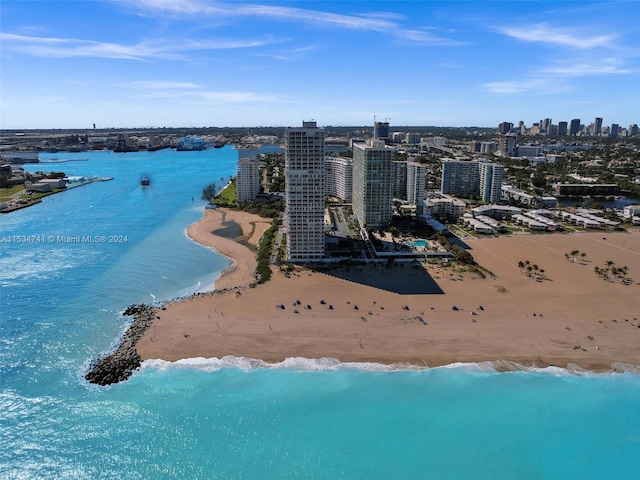 drone / aerial view with a beach view and a water view