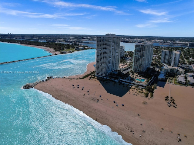 drone / aerial view with a water view and a beach view