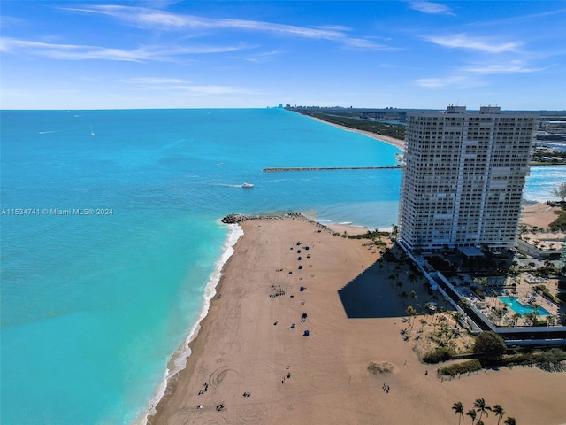 drone / aerial view featuring a water view and a beach view