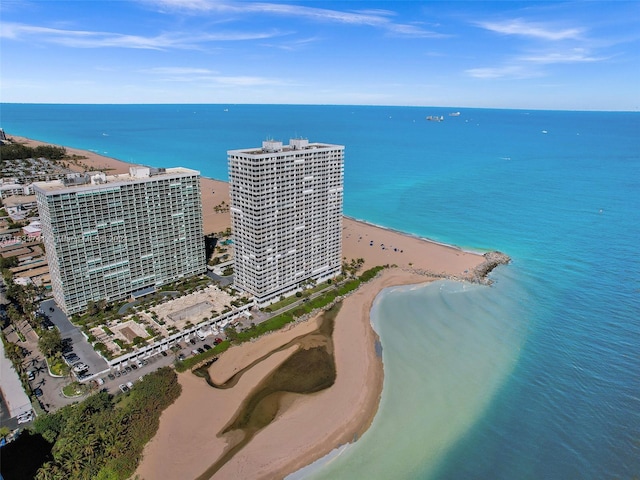 drone / aerial view with a beach view and a water view