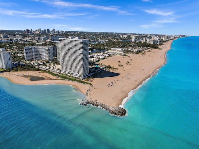 bird's eye view with a water view and a beach view