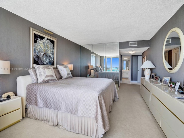 carpeted bedroom with a textured ceiling